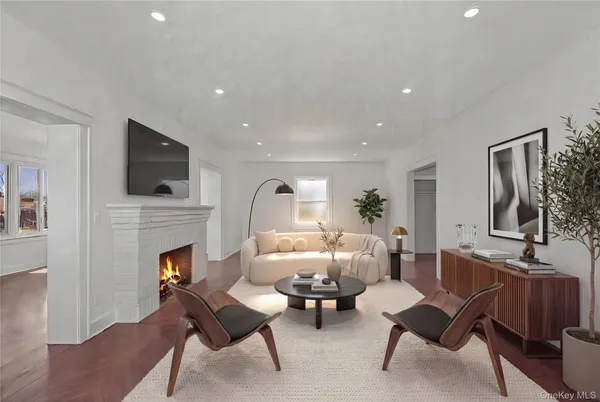 a living room with furniture a fireplace and a flat screen tv