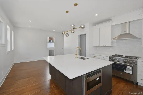 a kitchen that has a lot of cabinets a sink and a stove
