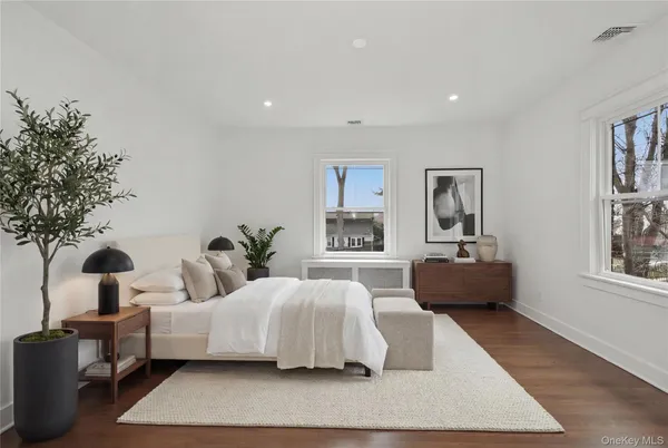 a bedroom with furniture and a large window