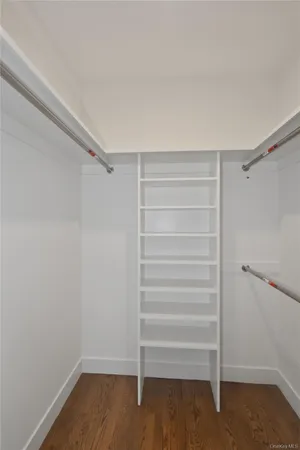 a view of walk in closet with empty racks