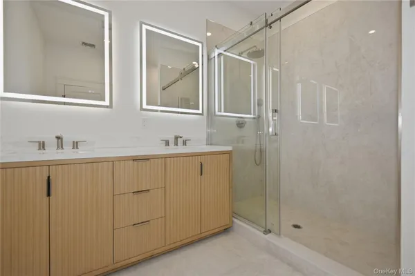 a bathroom with a shower sink and mirror