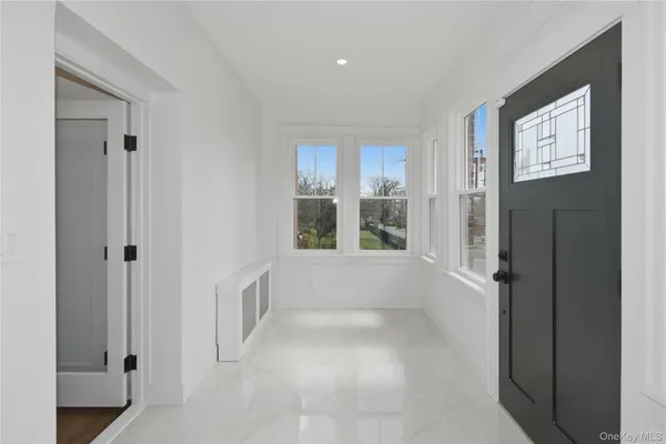 a view of an empty room with window and cabinet