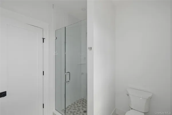a bathroom with a shower toilet and sink