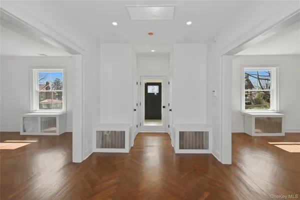 a view of a livingroom with wooden floor and windows