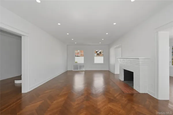 a view of empty room with fireplace and window