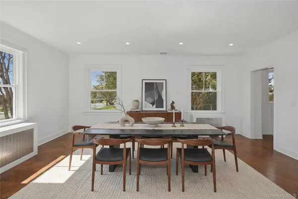 a dining room with furniture and wooden floor