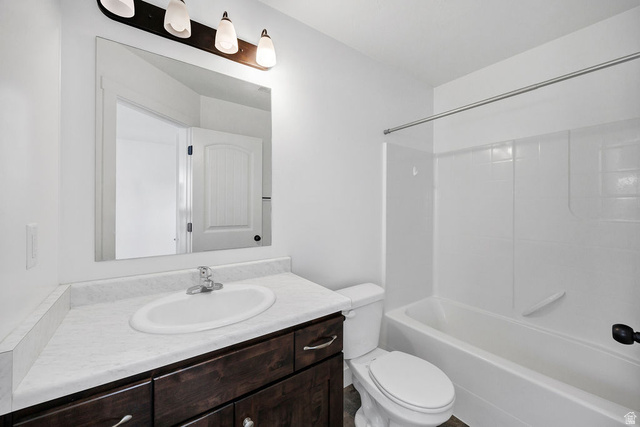 2483 South 1296th Street West Logan, UT 84321 - Photo 16 of 45 Bathroom featuring a vanity with dark wood-finish cabinetry, a white countertop, and an undermount sink