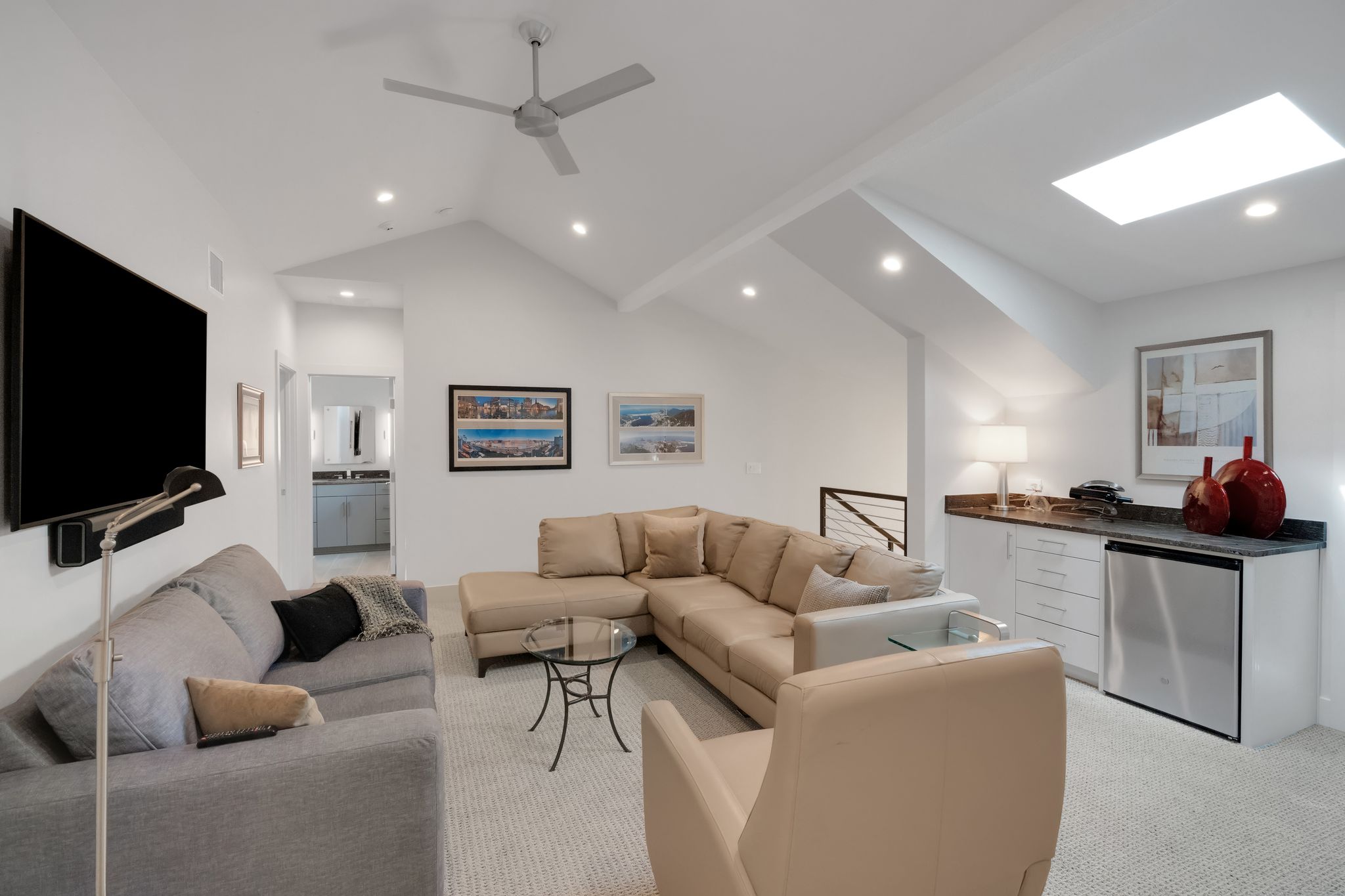 809 Bouldin Avenue Austin, TX 78704 - Photo 17 of 39 Living area with light colored carpet, a skylight, a ceiling fan, recessed lighting, and lofted ceiling