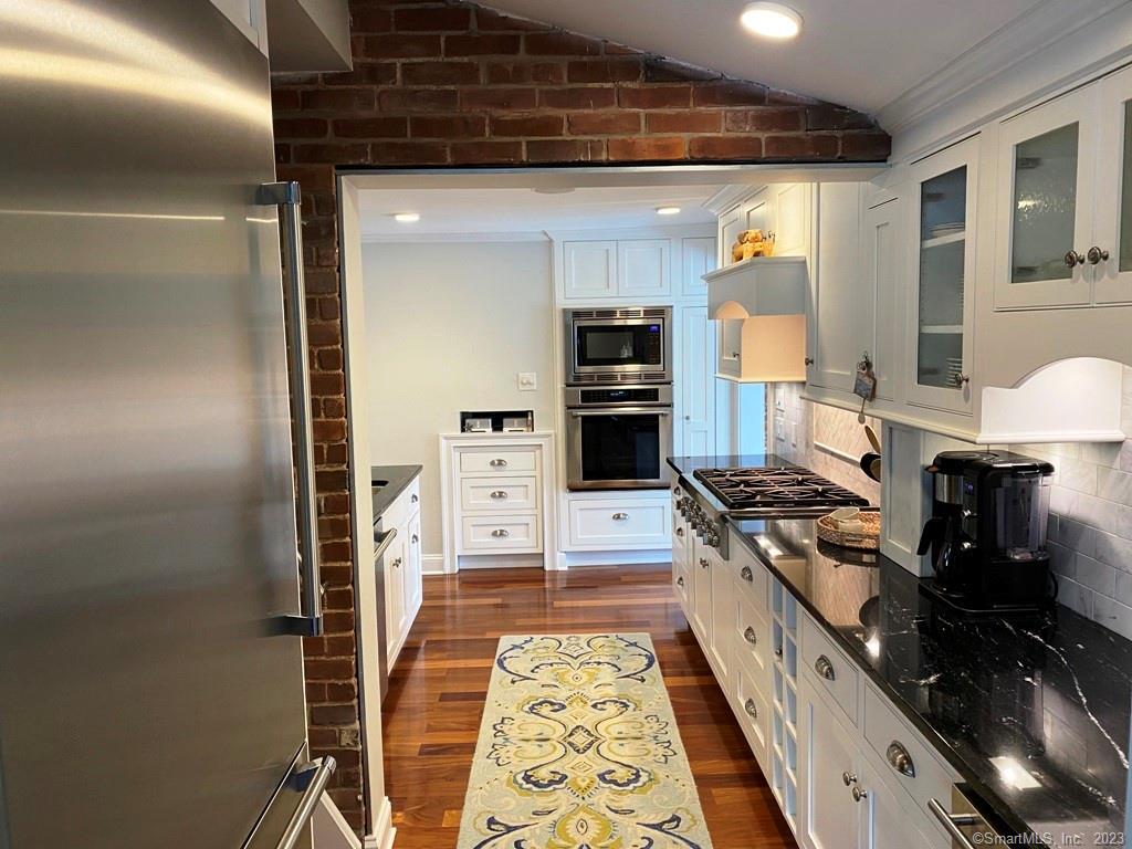 27 Brightwater Road Old Lyme, CT 06371 - Photo 11 of 34 a kitchen with stainless steel appliances granite countertop a stove and a refrigerator
