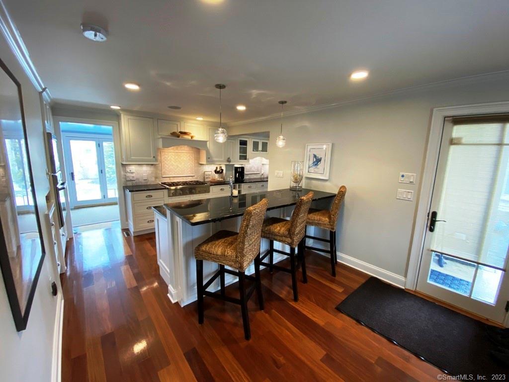 27 Brightwater Road Old Lyme, CT 06371 - Photo 13 of 34 a view of a dining room with furniture and wooden floor