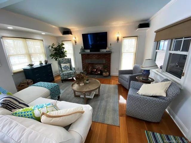 a living room with furniture fireplace and a flat screen tv