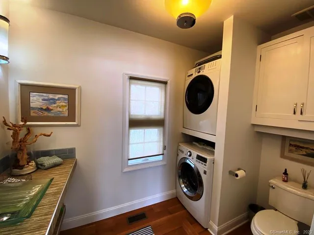 a utility room with dryer washer and a window