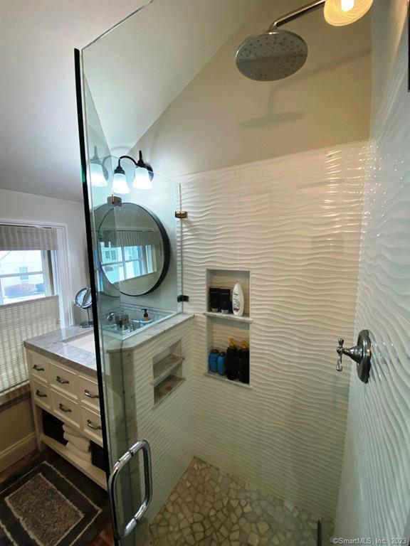 27 Brightwater Road Old Lyme, CT 06371 - Photo 24 of 34 a bathroom with a sink a mirror and a toilet