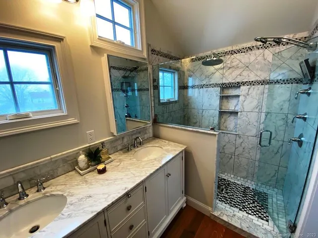 a bathroom with a sink double vanity and a shower