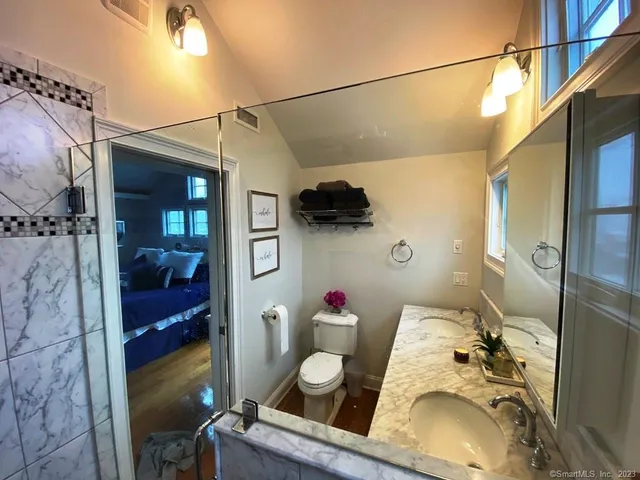 a bathroom with a sink toilet and shower