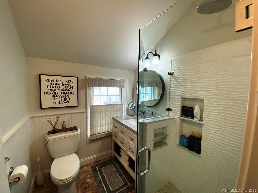 27 Brightwater Road Old Lyme, CT 06371 - Photo 34 of 34 a bathroom with a toilet a sink and mirror