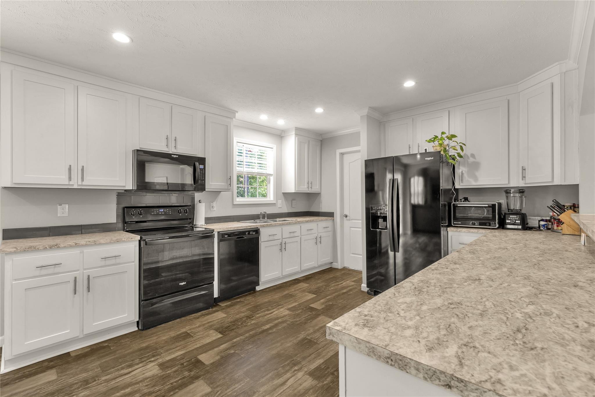 1652 Goings Road Chester, SC 29706 - Photo 11 of 35 a kitchen with refrigerator a microwave and cabinets