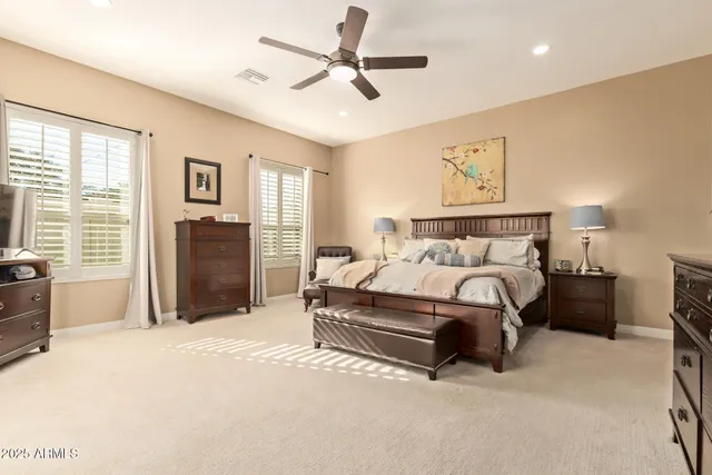 a spacious bathroom with a granite countertop sink a mirror and a bathtub