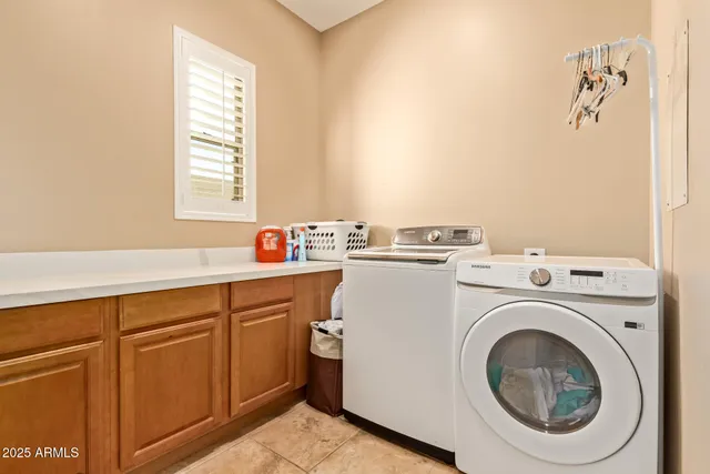 a living room with stainless steel appliances kitchen island granite countertop a sink and wooden floor