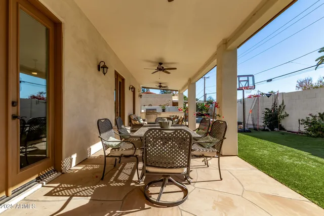 a view of a patio with table and chairs and potted plants