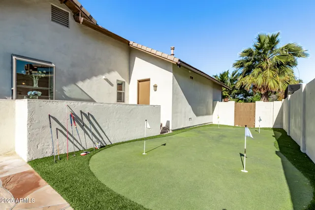 a view of a patio with table and chairs and potted plants