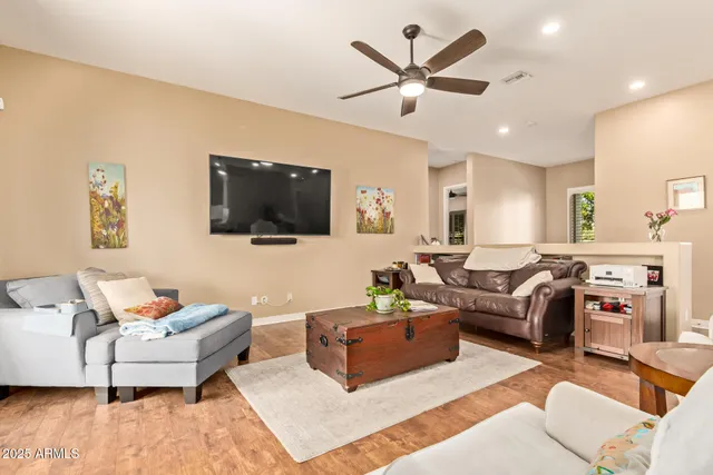 a living room with furniture fireplace and a large window