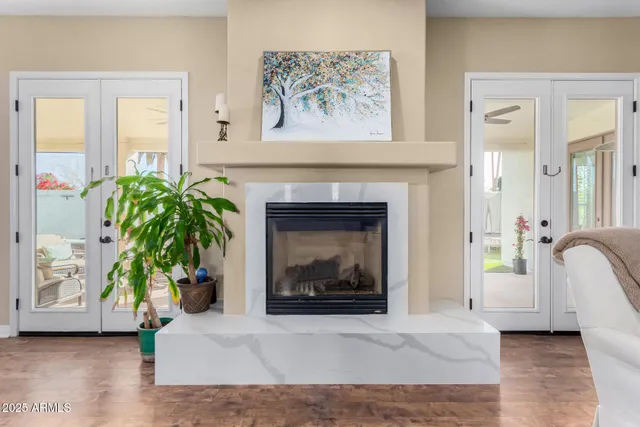 a living room with furniture a flat screen tv and a window