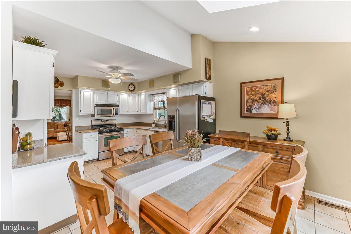 502 Ryanard Road Wallingford, PA 19086 - Photo 15 of 38 a dining room with stainless steel appliances kitchen island granite countertop a dining table and chairs