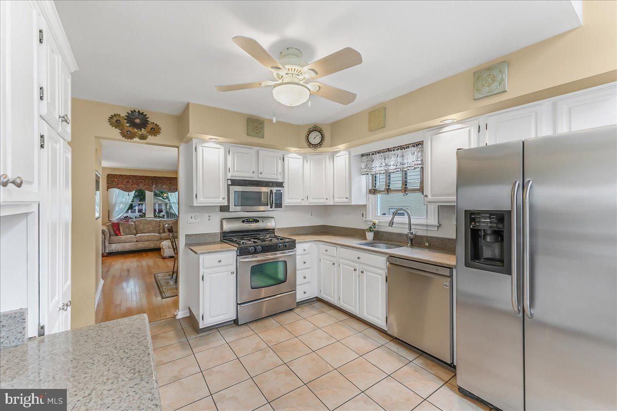 502 Ryanard Road Wallingford, PA 19086 - Photo 2 of 38 a kitchen with cabinets stainless steel appliances and a window