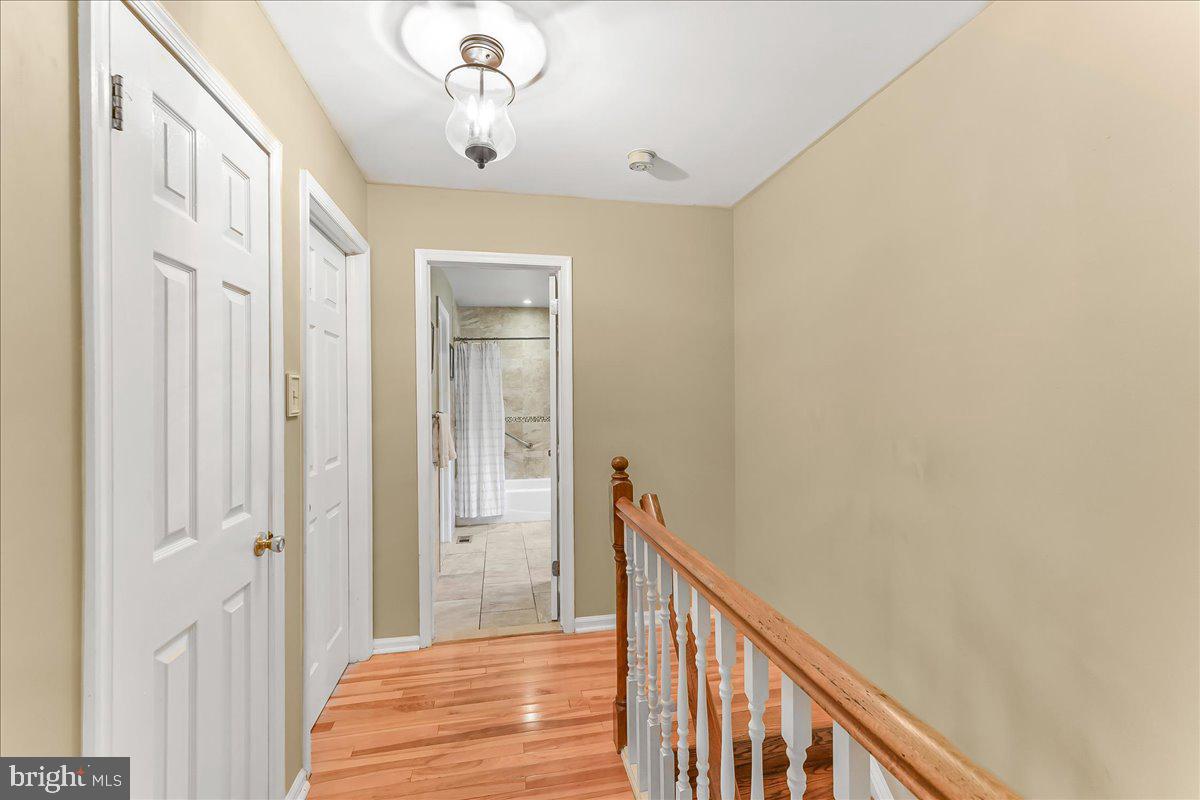 502 Ryanard Road Wallingford, PA 19086 - Photo 21 of 38 a view of a hallway with wooden floor and staircase
