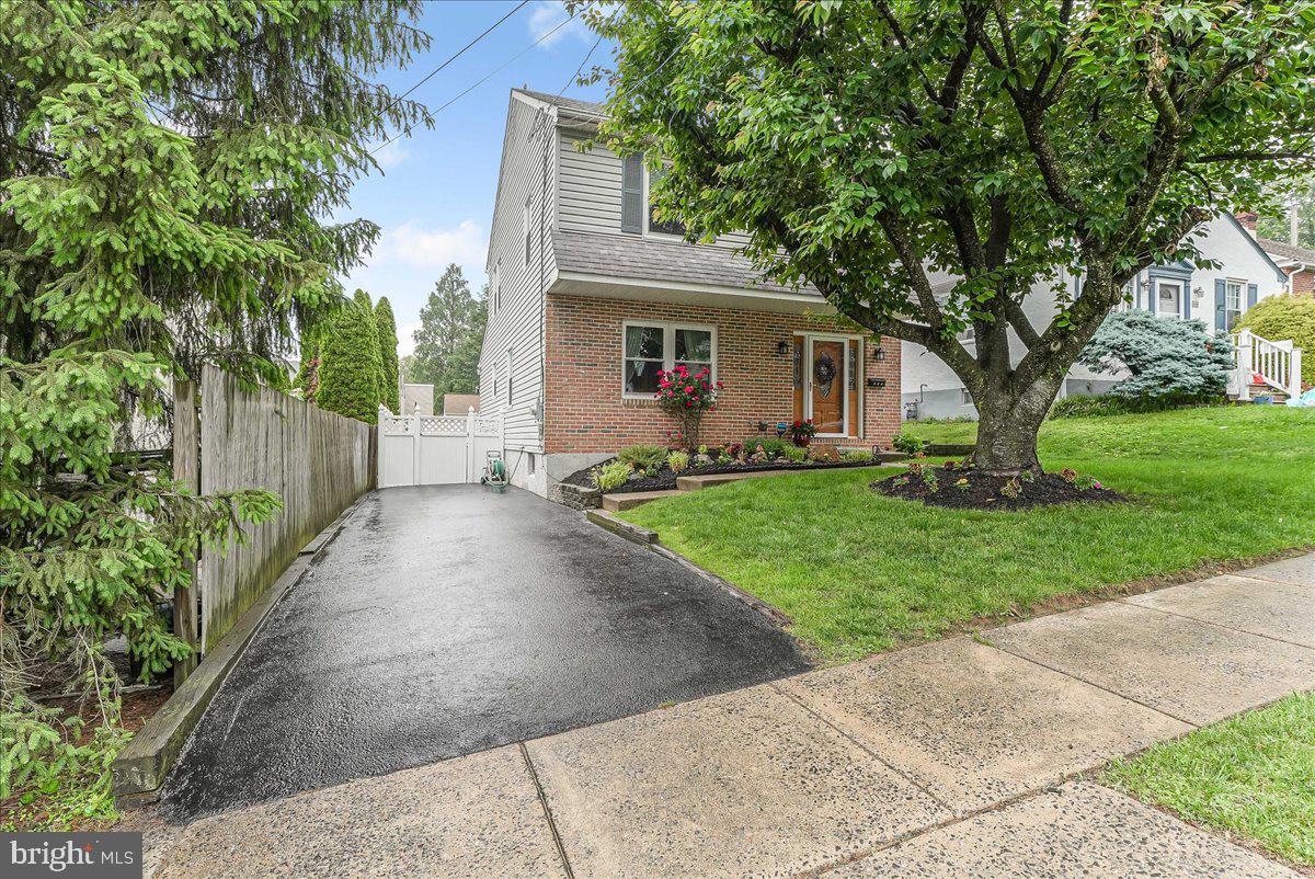 502 Ryanard Road Wallingford, PA 19086 - Photo 38 of 38 a front view of a house with a garden and trees