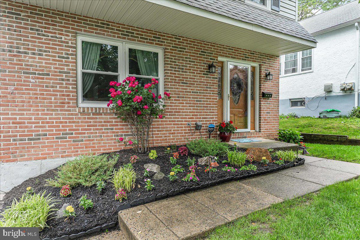 502 Ryanard Road Wallingford, PA 19086 - Photo 6 of 38 a front view of a house with a yard and flowers