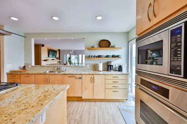 a kitchen with stainless steel appliances granite countertop a stove and a sink