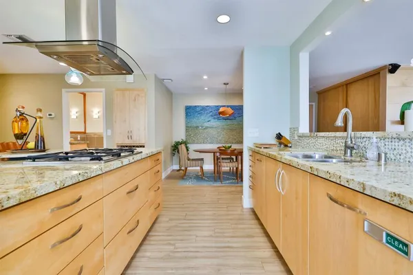a bathroom with a granite countertop sink and a large mirror