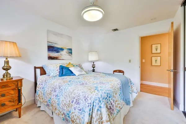 a bedroom with double bed and a lamp