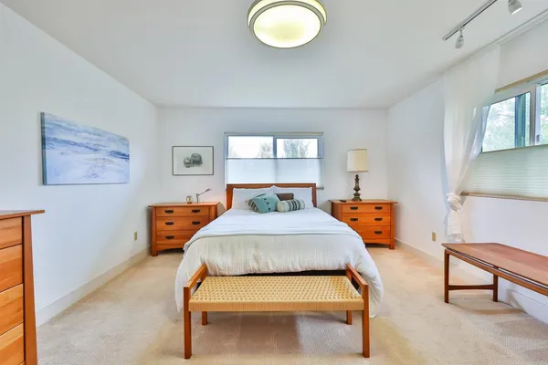 a bedroom with a bed and window