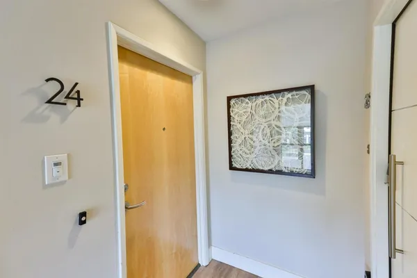 a bathroom with a shower and a painting on the wall