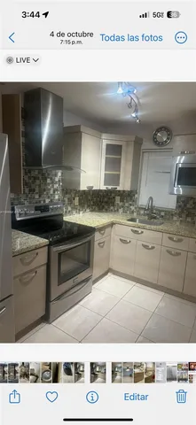 a kitchen with kitchen island granite countertop a sink and cabinets