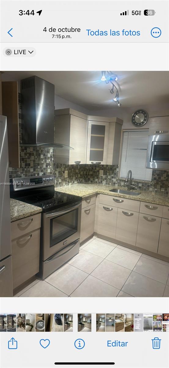 758 East 20th Street, Unit 2 Hialeah, FL 33013 - Photo 1 of 3 a kitchen with kitchen island granite countertop a sink and cabinets