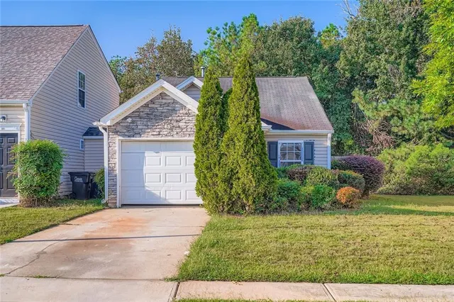 a front view of a house with garden