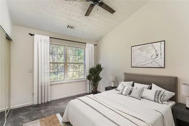 a bedroom with a bed and a painting on the wall