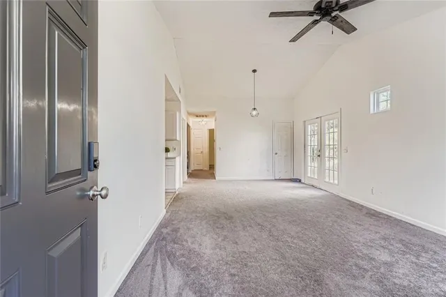a view of a room with a ceiling fan