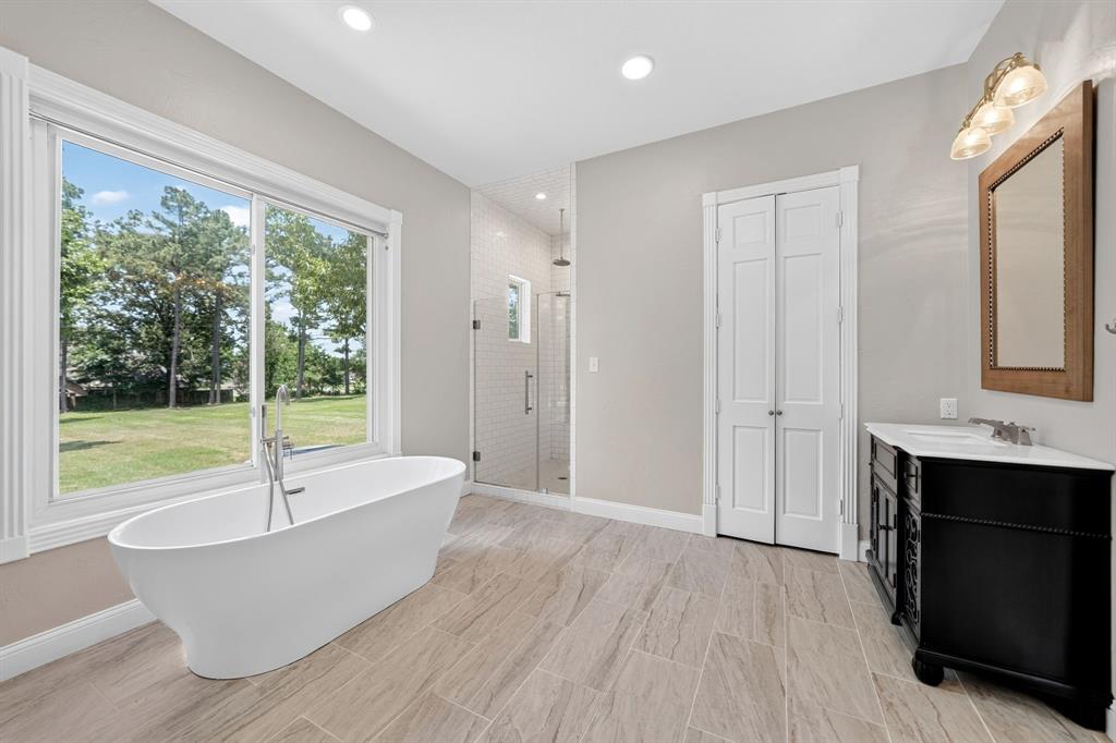 1201 Robbins Road Athens, TX 75751 - Photo 22 of 40 1st Floor- Primary Bathroom featuring a standalone soaking tub, glass shower, separate walk-in closets & separate vanities.