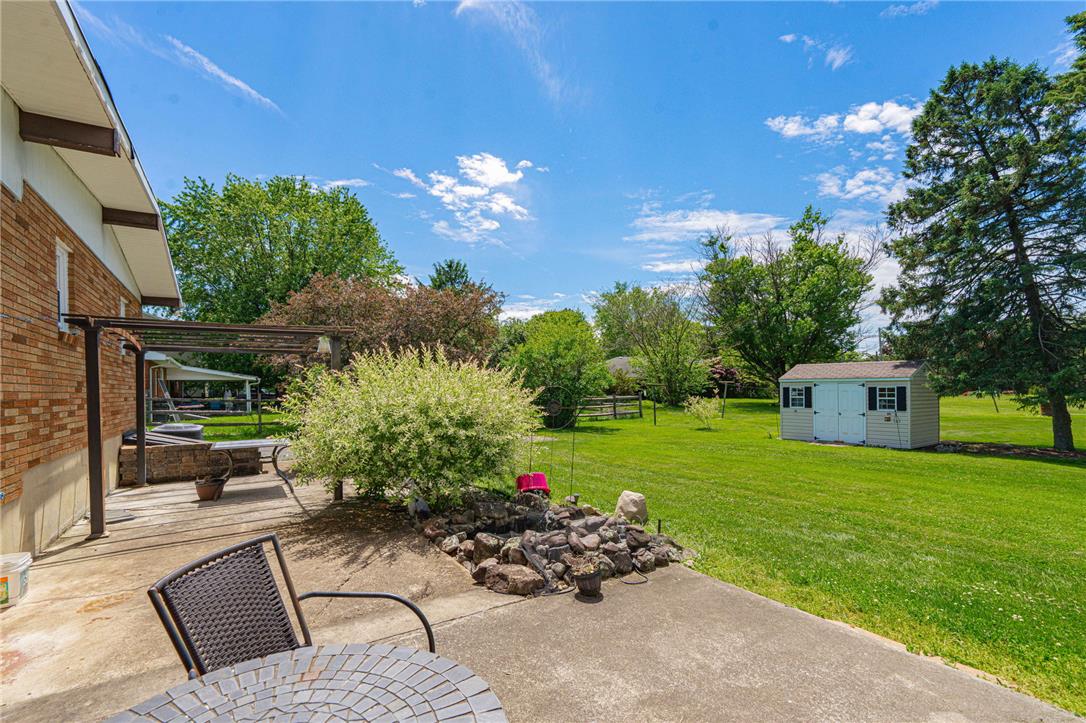 579 Cherry Road Northampton, PA 18067 - Photo 45 of 57 A spacious yard with mature trees and a charming garden shed create an inviting outdoor retreat.