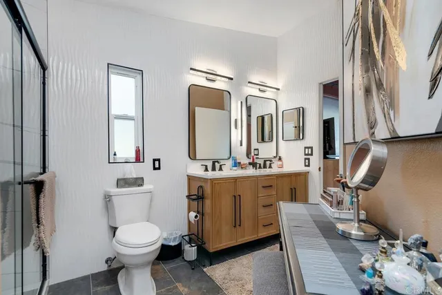 a bathroom with a toilet a sink and mirror
