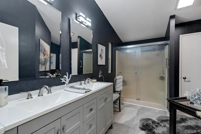 a bathroom with a double vanity sink mirror and double
