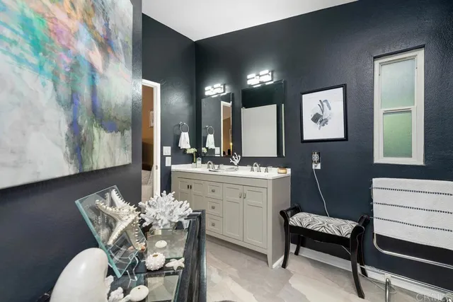 a bathroom with a sink vanity granite and a mirror
