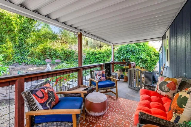 a balcony with furniture and rug
