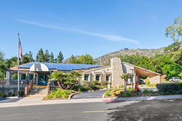 a view of a house with a yard and sitting area