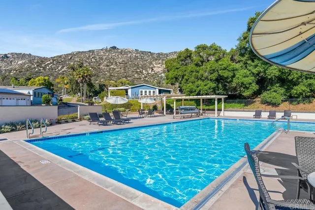 a view of a swimming pool with a patio and mountain view
